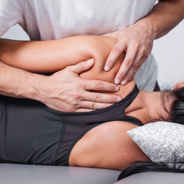 Body massage in spa. Physiotherapy back pain exercises.